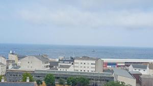 a group of buildings with the ocean in the background at BALCÓN DO MARIÑEIRO in Burela de Cabo
