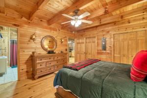 a bedroom with a bed and a ceiling fan at Forest Hideaway in Maggie Valley