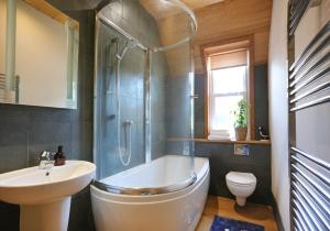 a bathroom with a tub and a sink and a toilet at East Road Apartment in North Berwick