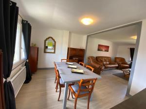 a living room with a table and a couch at La ferme Sainte-Damaris de la Maurienne 