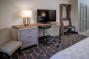 a living room with a tv and a chair at Holiday Inn Hotel & Suites Beckley, an IHG Hotel in Beckley