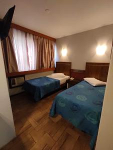Ένα ή περισσότερα κρεβάτια σε δωμάτιο στο Hotel Elo Curitiba