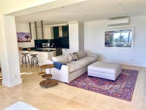 a living room with a couch and a table at Private Pool! Bantry Bay Large Flat with Solar in Cape Town