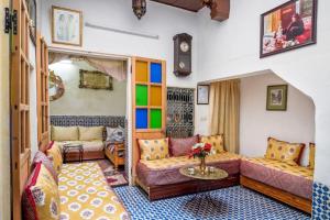 a living room with two couches and a table at Dar Fatimazahra in Fès