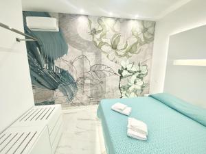 a bedroom with a blue bed and a mural at IL VIAGGIATORE RELAIS SUL MARE in Gaeta +37 photos