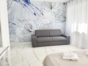 a living room with a couch in front of a wall at IL VIAGGIATORE RELAIS SUL MARE in Gaeta