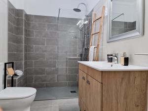 a bathroom with a toilet and a sink and a shower at DONA MARQUEZA - WiFi, AC, Praia & Centro Carvoeiro 350m in Carvoeiro +30 photos