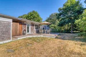 a home with a backyard with a deck and a house at Yellow Brick Road House in Oak Bluffs