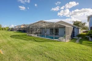 a house with a greenhouse in a yard at Remington View Retreat in Kissimmee