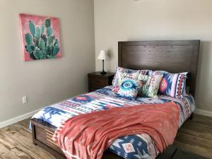 a bedroom with a bed with colorful pillows at PRIVATE VIEW ON THE LAKE SIDE OF 95! Sleeps 16 in Lake Havasu City