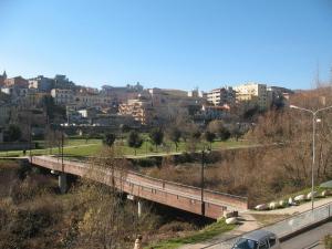 a bridge over a road in a city with buildings at Park Hotel Sporting in Teramo