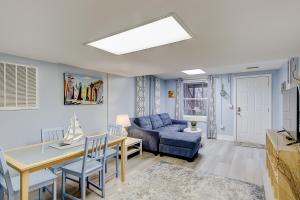 a living room with a blue couch and a table at SeaEscape in Folly Beach