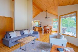 a living room with a blue couch and a table at Siuslaw River House in Mapleton