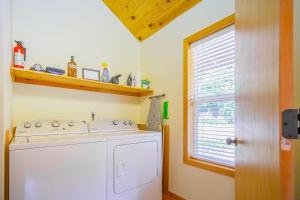 a washing machine in a kitchen with a window at Siuslaw River House in Mapleton +34 photos