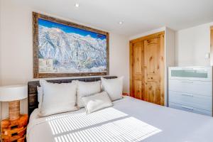 a bedroom with a bed and a painting on the wall at Tensleep B9 in Teton Village