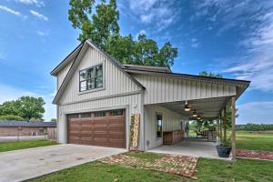 a house with a garage and a driveway at Spacious Apt Overlooking AR River Near Dtwn! in Russellville
