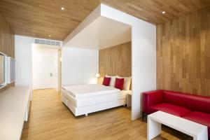 A bed or beds in a room at Revier Hotel Säntispark