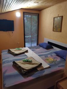 a bedroom with two beds with towels on them at Relax house in Visoko +14 photos