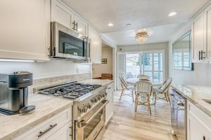 a kitchen with a stove and a table with chairs at Slide Creek Retreat in Bass Lake