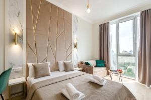 a hotel room with a large bed and a window at Modern new cozy apartment Kvartet Railway Station in Kyiv