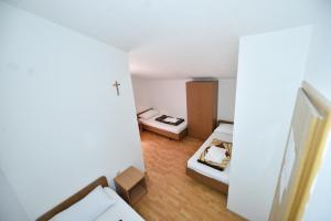 a small room with two beds and a hallway at Pansion Stojić in Međugorje