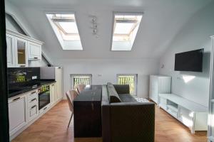 a kitchen with skylights and a table in a room at Studio Carolyne Bistrita in Bistriţa