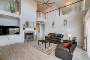 a living room with couches and a tv and a fireplace at Hill Country Haven in Lago Vista