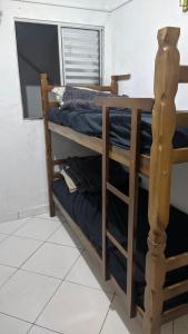 a pair of bunk beds in a room at Minha casa fora de casa in Jandira