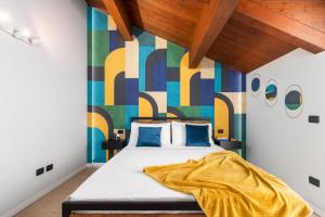 una camera con un letto con una parete colorata di Casa Gialla 7a, New Apartment Milano&Como a Bregnano