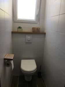 a small bathroom with a toilet and a window at Lou Mazet in Uchaud