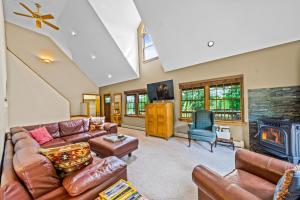 a living room with a couch and a fireplace at The Barn on Bartman in Johnsburg