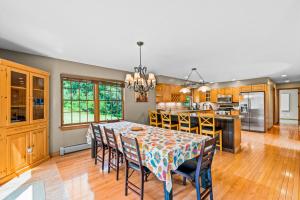 a dining room with a table and chairs in a kitchen at The Barn on Bartman in Johnsburg