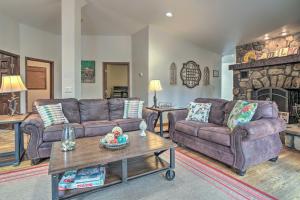 a living room with two couches and a fireplace at Home on Douglas Lake - Fish and Kayak! in Dandridge