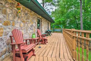 a wooden deck with chairs and a stone wall at Home on Douglas Lake - Fish and Kayak! in Dandridge