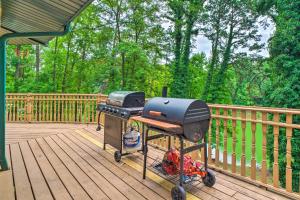 a grill sitting on a deck on a porch at Home on Douglas Lake - Fish and Kayak! in Dandridge