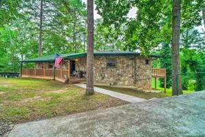 a stone house with an american flag in front of it at Home on Douglas Lake - Fish and Kayak! in Dandridge