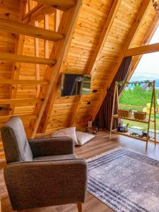 a living room with a wooden ceiling and a tv at SAPANCA BUNGALOVCA in Sapanca
