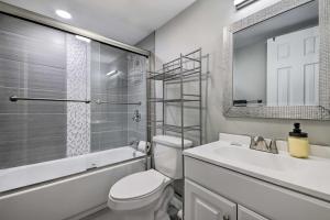 a bathroom with a toilet and a sink and a mirror at Furnished Deck and Lake Access Poconos Place! in Tobyhanna +22 photos