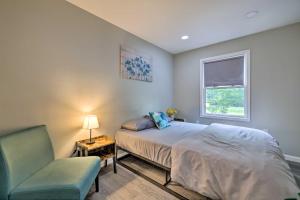 a bedroom with a bed and a chair and a window at Furnished Deck and Lake Access Poconos Place! in Tobyhanna