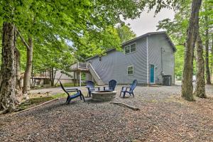 a group of chairs and a table in front of a building at Furnished Deck and Lake Access Poconos Place! in Tobyhanna