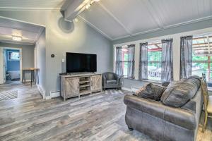 a living room with a couch and a flat screen tv at Cozy North Bend Getaway Near Dunes and Ocean! in Lakeside