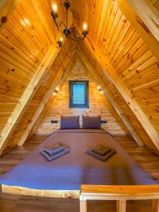 a bedroom in a log cabin with a large bed at SAPANCA BUNGALOVCA in Sapanca