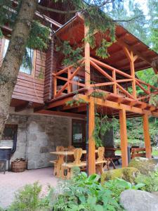 a tree house in the woods with a patio at TATRYSTAY Chalet Kristina in Belá