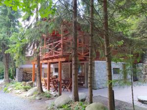 a house in the woods with a wooden structure at TATRYSTAY Chalet Kristina in Belá