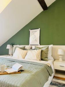 a bedroom with a large bed with green walls at Black Pearl by Vysehrad Castle in Prague