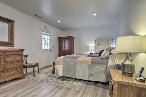 a bedroom with a bed and a dresser and a mirror at Outdoorsy Caliente Retreat with Screened Porch in Caliente