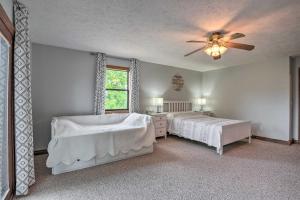a bedroom with two beds and a ceiling fan at Table Rock Lake Getaway with Fire Pit, Deck and Grill! in Golden