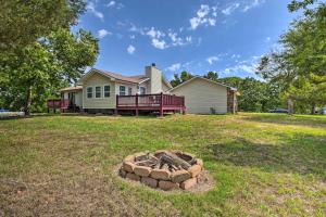 a yard with a fire pit in front of a house at Table Rock Lake Getaway with Fire Pit, Deck and Grill! in Golden