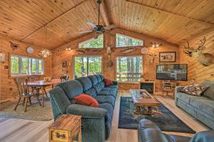 a living room with blue couches and a table at Atlanta Waterfront Cabin with Dock and Kayaks! 