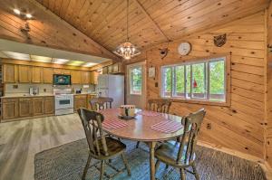 a kitchen and dining room with a table and chairs at Atlanta Waterfront Cabin with Dock and Kayaks! 